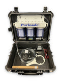 Purinade Five-Barrier water filtration system open in its hard case, showing three filter housings, 12V pump, hoses and housing wrench